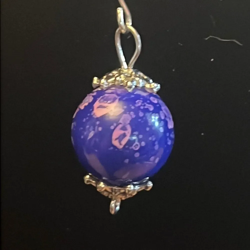 Handcrafted purple and silver tone earrings.
